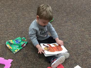 Toddler Looking at a Book