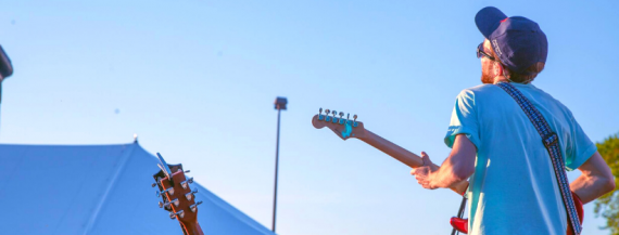 Image of musician David Paul Martin performing at an outdoor concert.