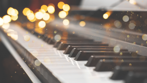 Image of Piano Keys with Lights in the Background