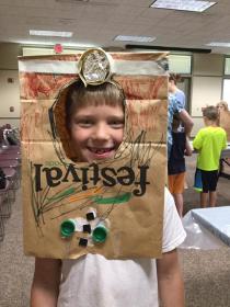 kid with paper bag craft