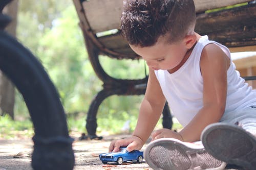 Child with toy car