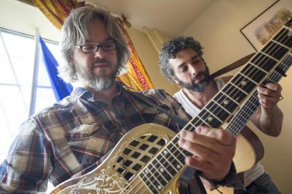 Image of Mal-O-Dua members, Christo and Ced, playing instruments.
