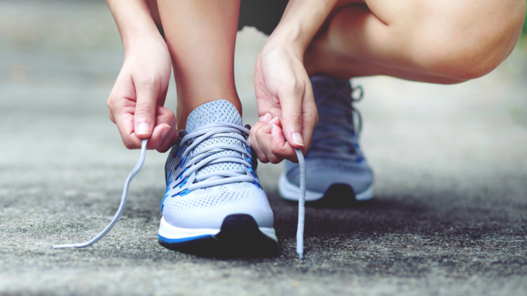 Person tying gym shoes