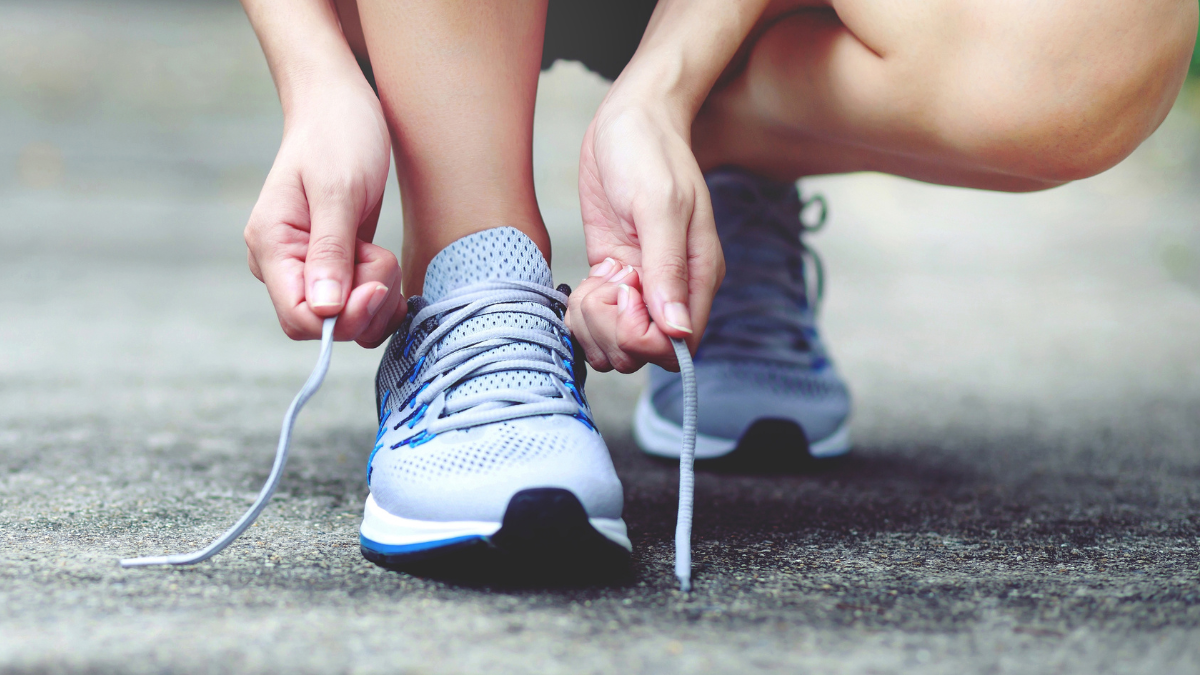 Person tying gym shoes